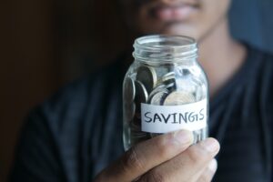 Person Holding a Savings Jar