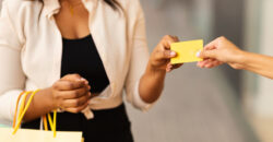 woman holding shopping bags and a gift card