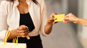 woman holding shopping bags and a gift card