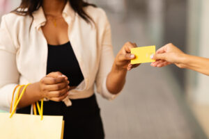 woman holding shopping bags and a gift card